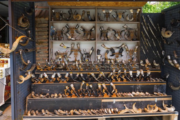 Souvenir stand with a large collection of traditional horns displayed on wooden shelves, Mtskheta, Mtskheta, Mtskheta-Mtianeti region, Georgia