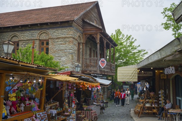 Busy old town street with traditional buildings and market stalls selling souvenirs, Mtskheta, Mtskheta, Mtskheta-Mtianeti region, Georgia