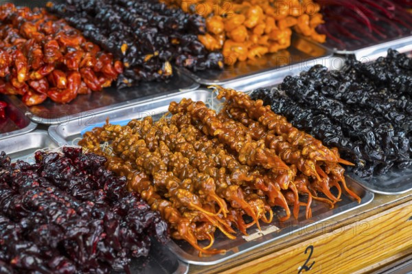 Plates of colorful Georgian sweets made from fruits and nuts at a market stand, Churchkhela, Georgian confections, 'Georgian Snickers', Mtskheta, Mtskheta, Mtskheta, Mtskheta-Mtianeti region, Georgia