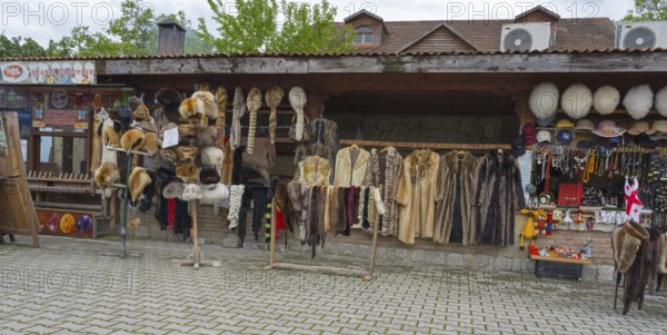 Market stall with fur hats and coats surrounded by souvenirs and traditional style, Mtskheta, Mtskheta, Mtskheta, Mtskheta-Mtianeti region, Georgia