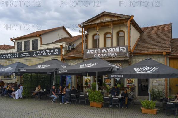 A cozy tavern with outdoor seating and lots of umbrellas, ideal for social gatherings, houses on Mtskheta Square, Mtskheta, Mtskheta, Mtskheta-Mtianeti region, Georgia