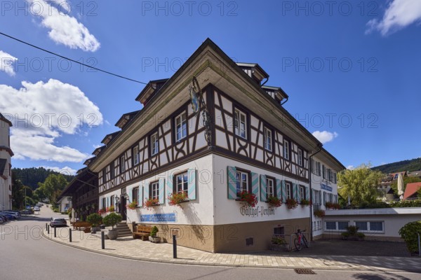 Landgasthaus Drei Schneeballen, inn, historic building, house, sidewalk, street, barrier bollard, curve, hill, coniferous forest, back light, side light, blue sky, cumulus clouds, main street, Hofstetten, Black Forest, Ortenaukreis, Baden-Württemberg, Germany