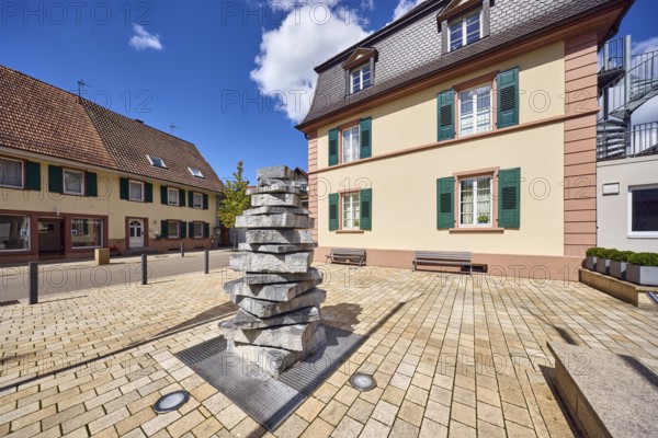 Buildings, town hall, residential and commercial buildings, benches, stacked stones, barrier bollards, blue sky, cumulus clouds, main street, Hofstetten, Black Forest, Ortenaukreis, Baden-Württemberg, Germany