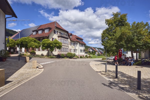 Gasthaus Lime tree, houses, general architecture, lantern, sidewalk, barrier bollard, hilly landscape, hills, coniferous forest, trees, blue sky, cumulus clouds, intersection of main street with Unterdorf, Hofstetten, Black Forest, Ortenaukreis, Baden-Württemberg, Germany