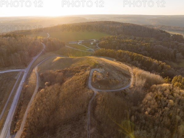 Landscape at sunset with hills and dense forest, future PV building on old deposit, Lindenrain industrial park, Calw, Germany