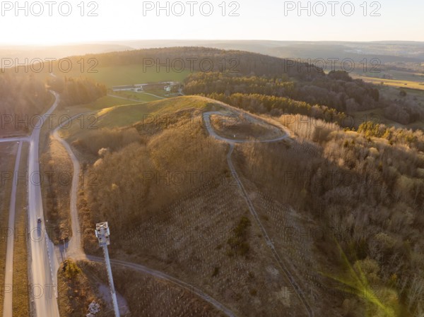 Evening landscape with hills, roads and extensive forests in soft light, future PV construction on old deposit, Lindenrain industrial park, Calw, Germany