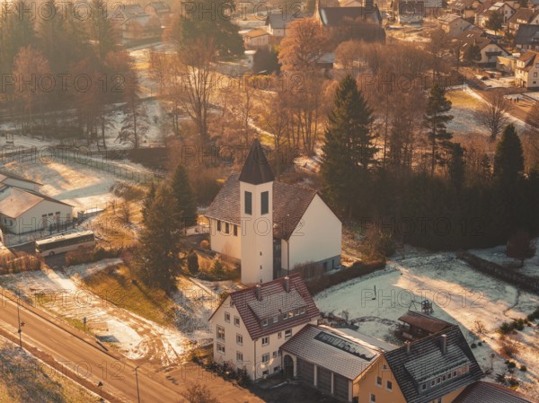 Close-up of a church in a small, snowy village surrounded by trees and a peaceful ambiance, Enzklösterle, Calw district, Germany