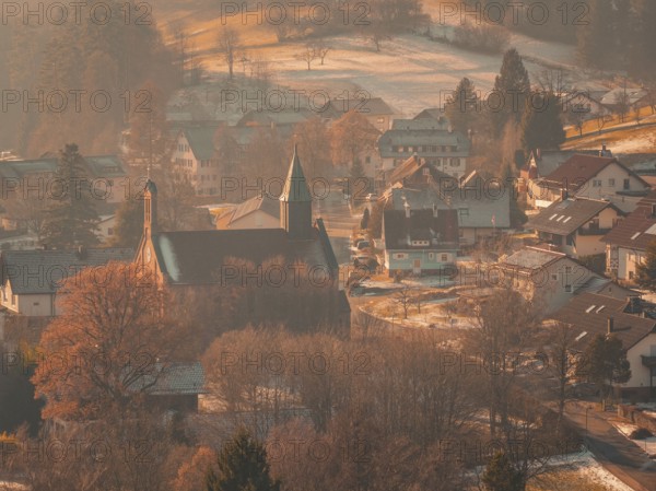 A small village with a church and snowy roads, nestled in a quiet, wintry environment, Enzklösterle, Calw district, Germany