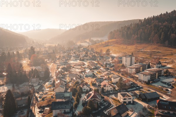 A village nestled in wintry hills, criss-crossed by sunshine and forest, Enzklösterle, Calw district, Germany