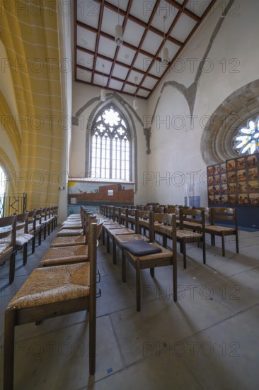 Church interior with rows of chairs and Gothic windows, quiet and devotional atmosphere, collegiate church, Herrenberg, Böblingen district, Germany