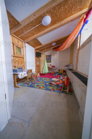 Colourful children's room with toys, wooden elements and carpet that radiates a cozy atmosphere, Herrenberg, Böblingen district, Germany
