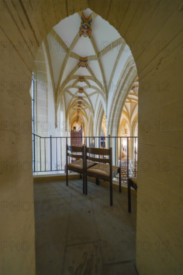 View through an arch of seats in a church with Gothic arches, quiet atmosphere, collegiate church, Herrenberg, Böblingen district, Germany