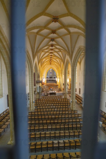 Symmetrical view of a church interior with altar and chairs, characterized by Gothic style, collegiate church, Herrenberg, Böblingen district, Germany