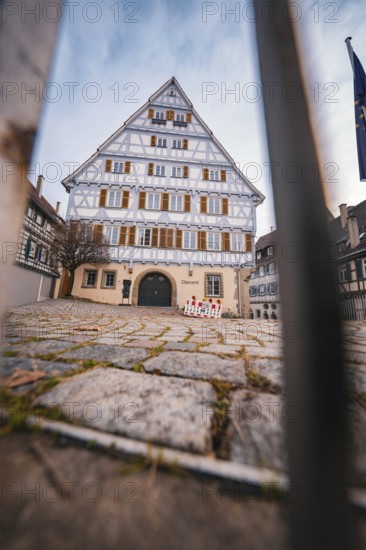 Large half-timbered house with symmetrical façade and grid in the foreground in a historic old town, Herrenberg, Böblingen district, Germany