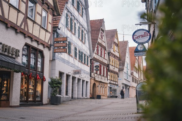A picturesque old town street with half-timbered buildings and shops that captures a historic city atmosphere, Herrenberg, Böblingen district, Germany