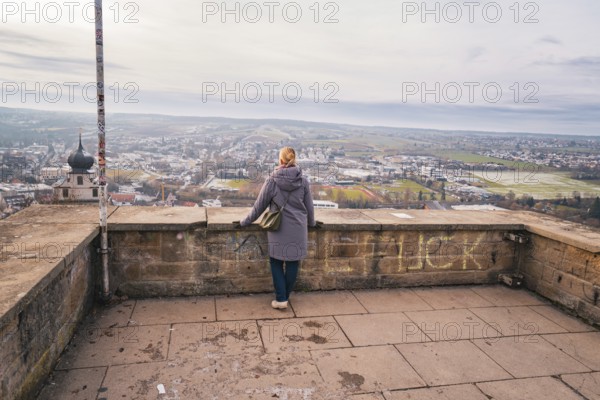 Quiet scene with a woman looking at the wide panorama from a platform, Herrenberg, Böblingen district, Germany