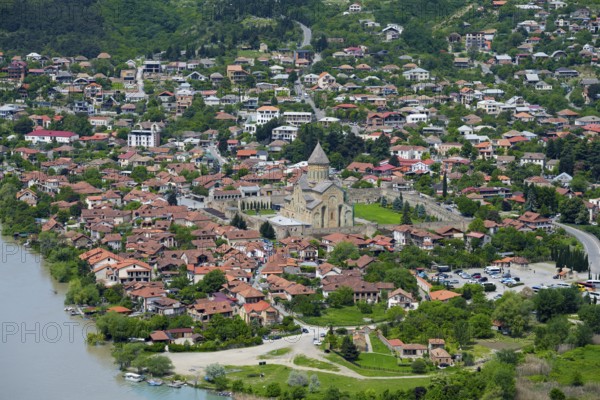 Panoramic view of a riverside town surrounded by green hills, view of Mtskheta, Mtskheta, Mtskheta-Mtianeti region, Georgia