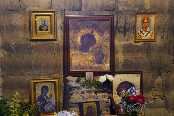 Religious icons on a stone wall with flower arrangement and candles, Javari Monastery, Jvari Monastery, Dzhwari Church, Cross Monastery, UNESCO World Heritage Site, Mtskheta, Mtskheta, Mtskheta, Mtskheta-Mtianeti Region, Georgia