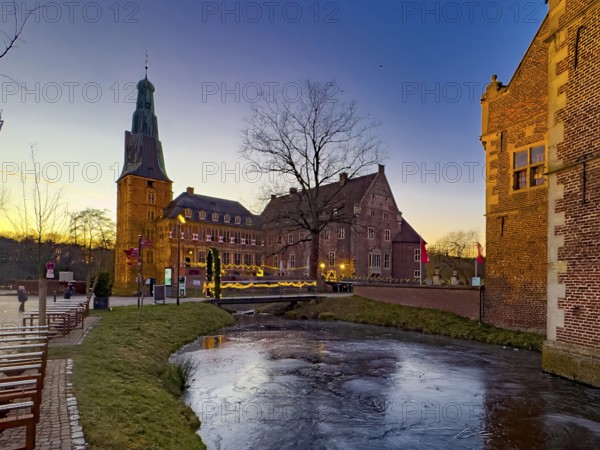 View in winter over a partially frozen moat at a castle converted into a Renaissance castle today Raesfeld moated castle from the 14th to 17th century with the main castle on the left, around part of Vorburg on the right, Freiheit Raesfeld, Hohe Mark nature park Park, Münsterland, North Rhine-Westphalia, Germany