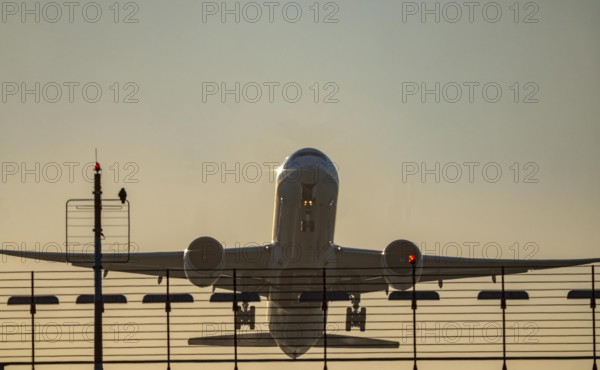 Runway lighting, approach aids, at Düsseldorf International Airport, sunset, aircraft taking off, Hauptbahn Süd, 05R/23L, Emirates Boeing 777, North Rhine-Westphalia, Germany
