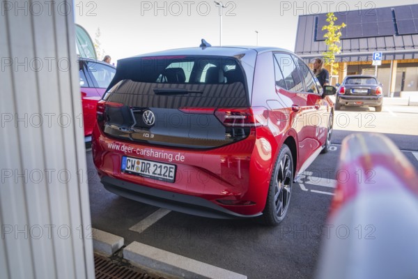 Red Volkswagen car sharing car in parking lot, modern design and urban environment, ID3, Deer e- car sharing, Germany