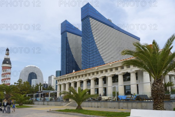 Blue skyscrapers with innovative design stand in an urban setting with palm trees and busy streets, Orbi City Hotel Complex and Restaurant Veranda Acropolis, Batumi, Black Sea, Ajara Region, Adjara, Autonomous Republic, Georgia