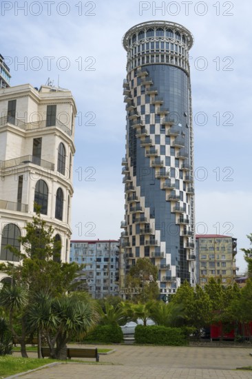 A modernly designed high-rise building with spiral balconies rises above the surrounding green areas, Black Sea Tower, Batumi, Black Sea, Ajara region, Adjara, Autonomous Republic, Georgia
