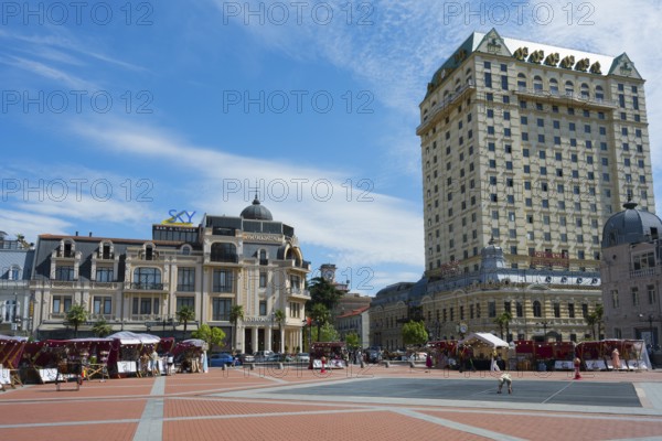 Open square with tall buildings and market stalls under a cloudy sky, Royal Casino and Hotel on the left, Princess Casino, Europe Square, Batumi, Black Sea, Ajara region, Adjara, Autonomous Republic, Georgia