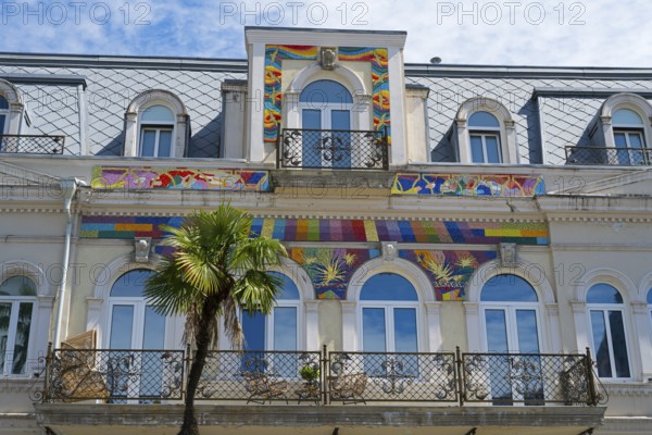 Detailed view of a building with colorful ornaments and palm trees in front of the balcony, Europe Square, Batumi, Black Sea, Adjara region, Adjara, Autonomous Republic, Georgia