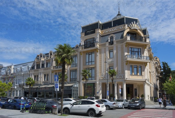 Elegant building with decorated facades and palm trees in front of a parking lot, Royal Casino and Hotel, Europe Square, Batumi, Black Sea, Ajara region, Adjara, Autonomous Republic, Georgia