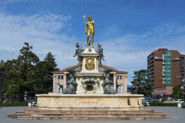 A fountain with a golden Neptune statue surrounded by water figures in front of a building, Neptune Fountain, Theatre Square, Batumi, Black Sea, Ajara region, Adjara, Autonomous Republic, Georgia