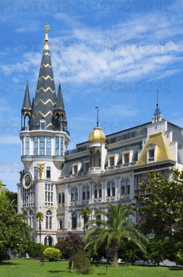Tower with golden dome in an impressive building with palm trees, Astronomical Clock, Black Gold Roof, Europe Square, Batumi, Black Sea, Ajara Region, Adjara, Autonomous Republic, Georgia
