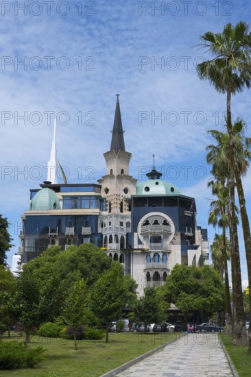 Historically inspired building with tower and palm trees, former registry office, now administrative building of the government of Adjara, Batumi, Black Sea, Ajara region, Adjara, autonomous republic, Georgia