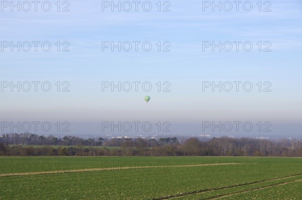 Hot air balloon, landscape, winter, in the sky, colors, atmospheric, North Rhine-Westphalia, Germany, A balloon floats in the air over fields, trees and houses