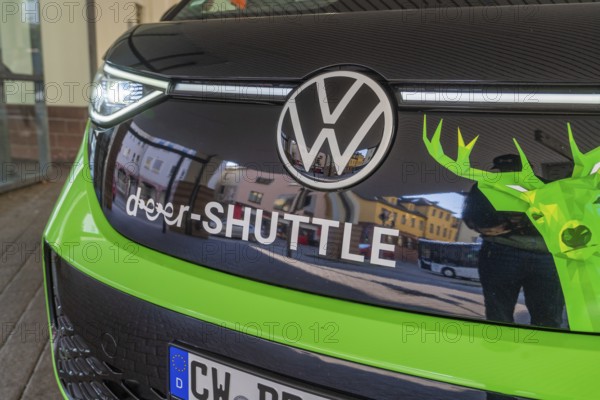 Close-up of the front part of a VW with green-black colors, Deer E-Mobility Shuttle Service, Calw, Germany