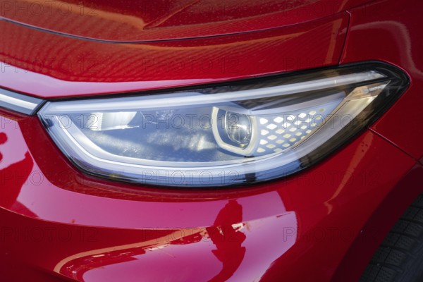 Red car light with modern headlight design in close-up, Deer E-Mobility Shuttle Service, Calw, Germany