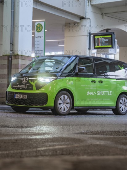 Green shuttle at a bus stop, equipped with digital display and urban design, Deer E-Mobility Shuttle service, Calw, Germany
