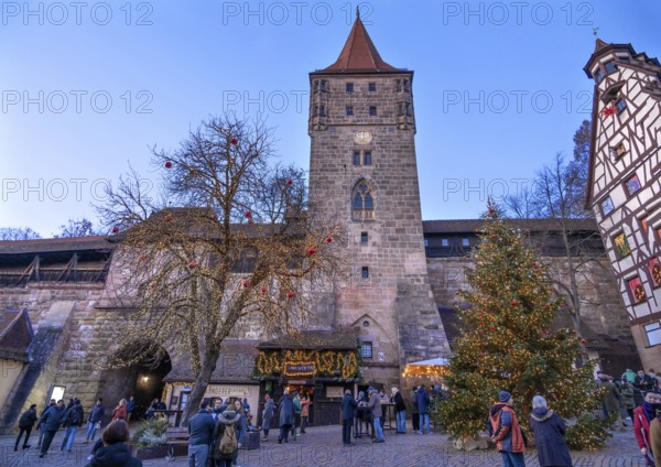 Christmassy decorated square in front of the historic Tiergärtnertorturm, built in the 13th century, in the evening sun, Beim Tiergärtnertor, Nuremberg, Middle Franconia, Bavaria, Germany