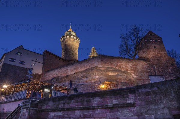 Illuminated Sinwell Tower, built in the 13th century, in the evening sky, Kaiserburg, Nuremberg, Middle Franconia, Bavaria, Germany