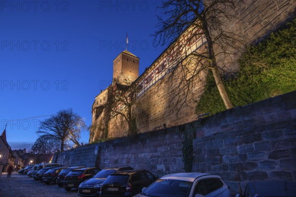 Nuremberg Kaiserburg in evening lighting, blue evening sky, cars parked below on the castle wall, Ölberg, Nuremberg, Mittelfranlen, Bavaria, Germany