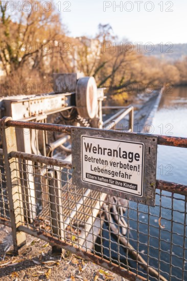 Fortification on a river with a prohibition sign in autumn, Stadtgarten Pforzheim, Germany