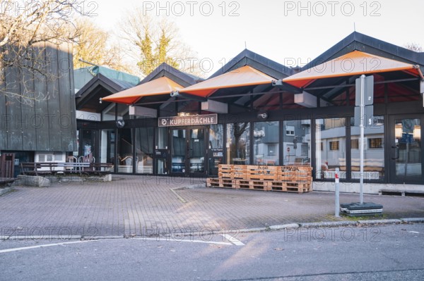 Empty urban building complex surrounded by autumn trees, Stadtgarten Pforzheim, Germany