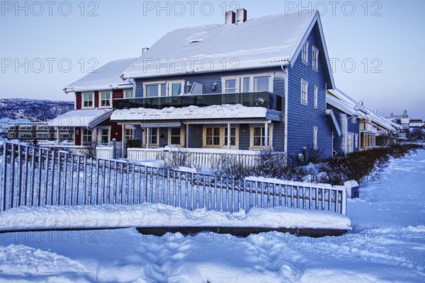 Snowy blue house in winter, Mo i Rana, Norway