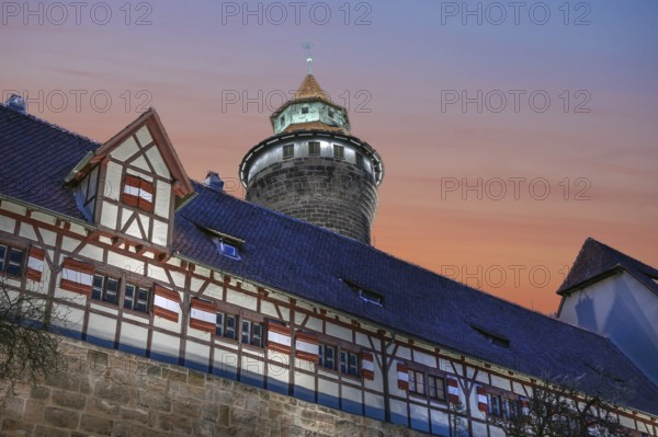 Sinwell Tower built in the 13th century, on the Nuremberg Kaiserburg in the evening lighting, red evening sky, Mount of Olives, Nuremberg, Middle Franconia, Bavaria, Germany