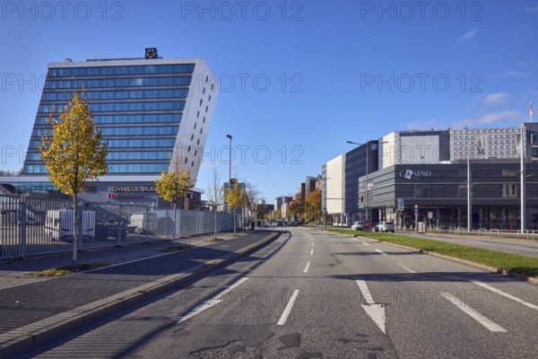 Schwedenkai ferry terminal, casino, general buildings, commercial buildings, modern architecture, lanes, central island, road markings direction arrow, lantern, cars, trees, autumn leaves, lawn, metal fence, blue sky, cumulus clouds, Kaistraße street, Kiel, state capital, district-free city, Schleswig-Holstein, Germany