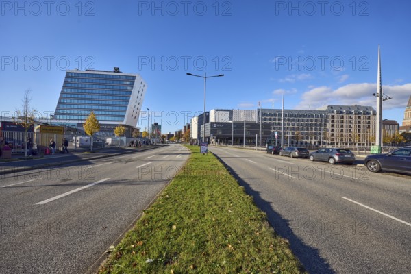 Schwedenkai ferry terminal, casino, hotel, Accor Group, Adagio Access, ibis Styles, general development, commercial buildings, modern architecture, lanes, central island, lantern, trees, lawn, metal fence, parking strips with cars, pedestrians as accessories, blue sky, cumulus clouds, Kaistraße street, Kiel, state capital, district-free city, Schleswig-Holstein, Germany