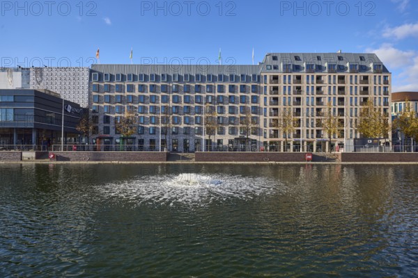 Boat harbor, water area, lake, ventilation pump, abstract reflections on the water surface, general architecture, building, modern architecture, hotel, Accor Group, ibis Styles, Adagio Access, façade with windows, trees, blue sky, cumulus clouds, Holstenbrücke street, Kiel, state capital, district-free city, Schleswig-Holstein, Germany