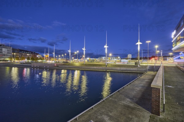 Boat harbor, water area, general architecture, modern buildings, abstract reflections on the water surface, evening blue hour, deep blue evening sky, cumulus clouds, quay road, Kiel, state capital, district-free city, Schleswig-Holstein, Germany