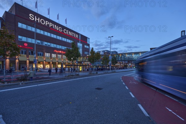 Sophienhof Kiel shopping center, modern architecture, brick building, commercial building, lantern, public bus, motion blur, light trails, cycle path, road, road marking cycle path, pedestrian as accessories, evening blue hour, blue evening sky, cumulus clouds, Sophienblatt, Kiel, state capital, district-free city, Schleswig-Holstein, Germany