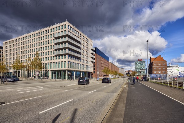 General architecture, brick building, modern building, street, sidewalk, cycle path, lantern, Atlantic Hotel, trees, autumn leaves, vehicles, pedestrians and cyclists as secondary motifs, blue sky, cumulus clouds, stratocumulus clouds, cumulonimbus clouds, white and dark clouds, intersection of Kaistraße, Raiffeisenstraße and Kiel Sailors Square, Kiel, state capital, district-free city, Schleswig-Holstein, Germany